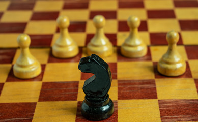 Chess set on the chess board. With selective focus on black  knight
