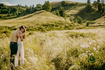 Love Couple in love romantic road summer field happy. Russia. lake aslykul