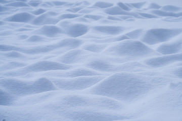 Fresh bumpy snow landscape in freezing blue tone for background.