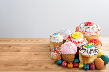 lovely composition Russian Easter cakes in glaze on a wooden table with quail colored eggs