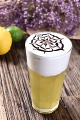 cup of coffee with whipped cream on wooden background