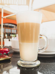Glass cup of coffee latte close up