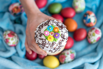 beautiful decorated sweet Easter bread with icing in hand