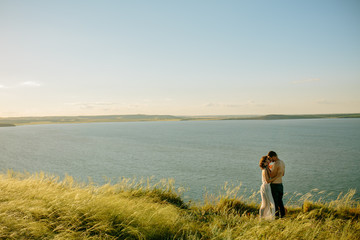 Love, romantic and nature concept - young couple hugging near the lake. Russia