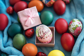 colored Easter eggs in gift box on blue background