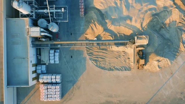 Aerial top view of dry mix concrete batch plant in industrial area 