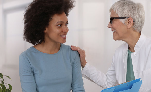 Mature Doctor Comforting Young Woman Patient. Professional Medical Help,support, Advice Female Health , Gynecology Concept