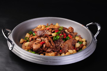 beef stew with vegetables and meat in pan on white background