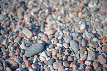 Pebbles in different sizes in warm evening light, short depth of focus