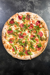 Pepperoni pizza with fresh arugula