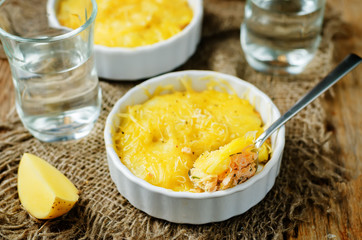 Salmon potato casserole with glasses of water