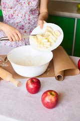woman cooking dough for cake, she mixing butter and flour on the bowl on the white table