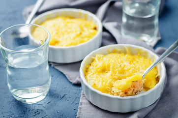 Salmon potato casserole with glasses of water