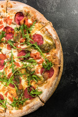 Pepperoni pizza with fresh arugula