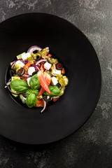 Fresh salad.Concept for a tasty and healthy meal. Dark stone background.