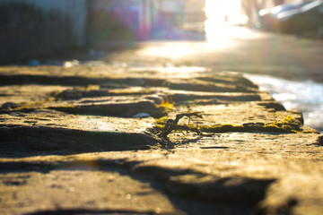the sun at sunset on the stone masonry
