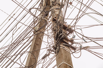  a telegraph pole with many wires and communication lines