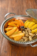 dried apricots in bowl on wooden table