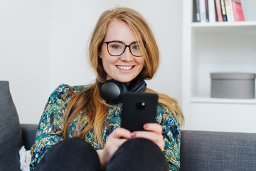 Young woman listening to music at home