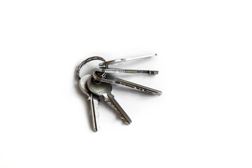 Several keys on a white isolated background,the keys to the apartment.