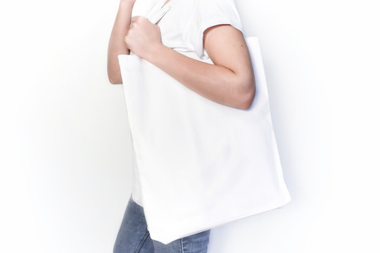 A girl with a white shopping bag. Concept: ecology, no plastik. Copy space