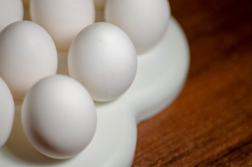  chicken eggs standing on the top of the mountain from other eggs with a backlight