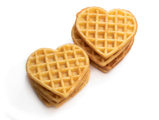 Stacks of heart shaped waffles isolated on white