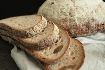Sliced bread  on black background. Crumbs and fresh Bread slices close up. Bakery, food concept .Fresh large homemade bread 