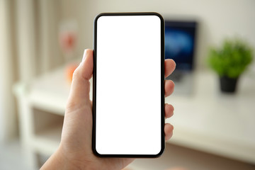 female hands holding phone with isolated screen in the room