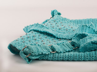 Women's accessories: Blue knitted clutch on a white background. Handmade. Fashion. Advertising. Close-up