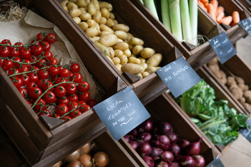 A rustic display of organic vegetables for sale at a farm shop