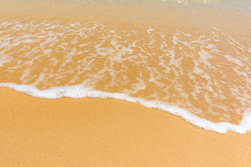 Fototapeta na wymiar Wave of the sea on the sand beach background