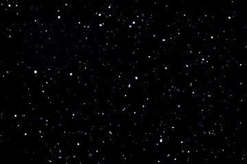 Falling snow on black background Snowflakes Flying in the air.