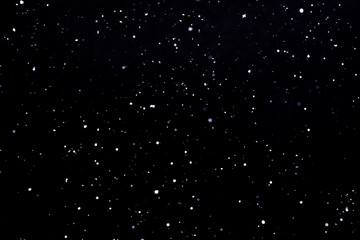 Falling snow on black background Snowflakes Flying in the air.