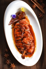 grilled sausages with sauce and vegetables on white plate