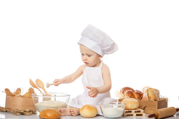 Happy smiling boy chef white uniform isolated on white background. Portrait image. Cooking child lifestyle concept. Toddler playing