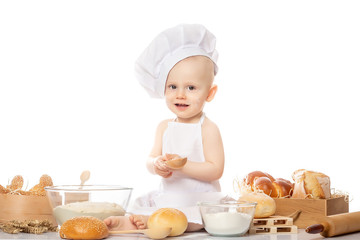 Portrait of a little chef hat and apron. Cooking child lifestyle concept. Toddler playing
