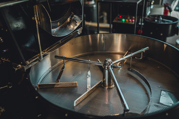Coffee roasting in small roastery. Coffee roasting machine, Production of coffee.