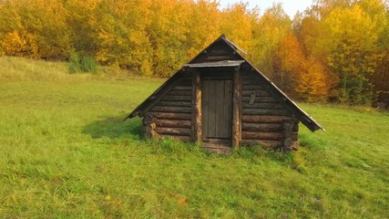 Old, handmade log cabin in an agricultural field in Rural Ukraine