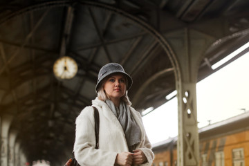 A woman stands on the platform of the train. Travelling by train. Waiting for a long trip