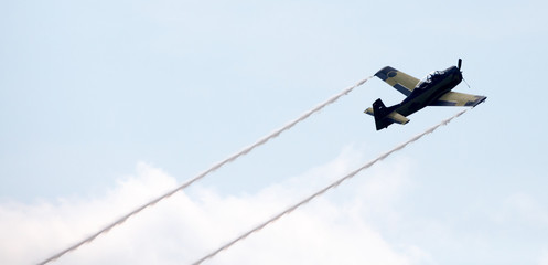 old airplane with contrails and curly smoke 