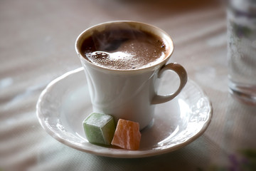 Turkish coffee with milk cream chocolate pistachio Turkish delight and cup of water