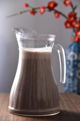 jug and glass of water on wooden table