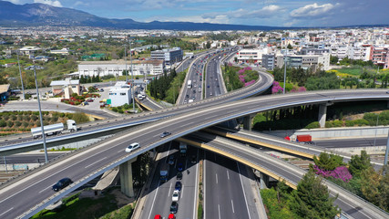 Aerial drone view of popular highway multilevel junction road, passing through National motorway in traffic jam