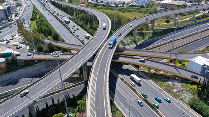 Aerial drone view of popular highway multilevel junction road, passing through National motorway in traffic jam