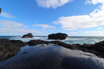 Fototapeta na wymiar Rocky Pool by Ocean with Blue Sky