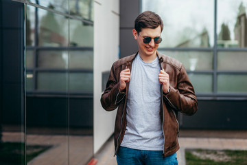 A stylish man in a gray  T-shirt. Street photo