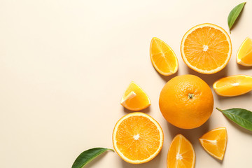 Flat lay composition with ripe oranges and space for text on color background