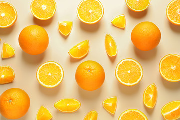 Flat lay composition with ripe oranges on color background