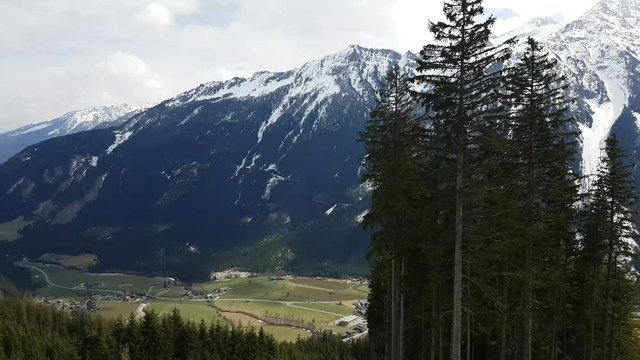 Alps panorama view in spring. Snowy peaks and green valley. Austrian Alps and panorama view.